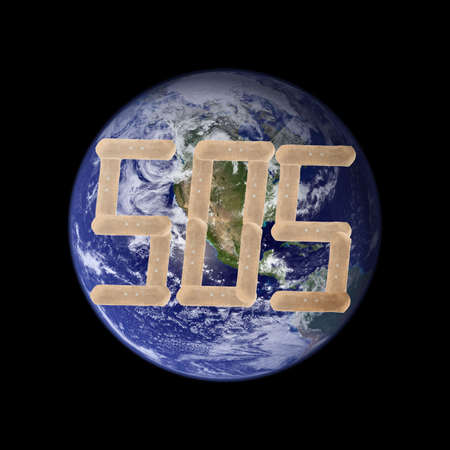 A picture of the earth with two band-aids forming a cross. Earth picture is taken from NASA.の写真素材