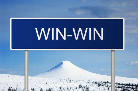 A blue road sign with white text saying win-winの写真素材