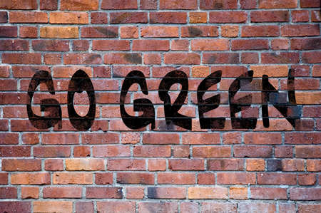 The letters go green made up of grafitti letters against a brick wall, could be used as environmental, green or ecoogical imagery.の写真素材