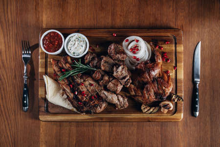 assorted grilled meat served woodenの写真素材