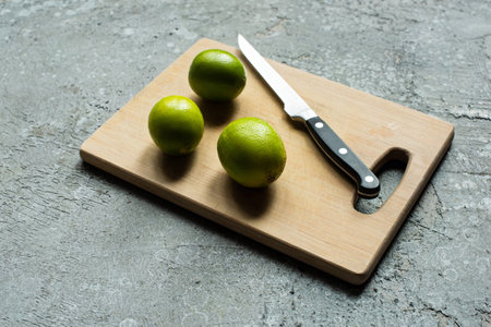ripe limes wooden cutting boardの写真素材