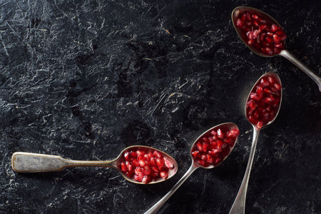 flat lay spoons garnet seedsの写真素材