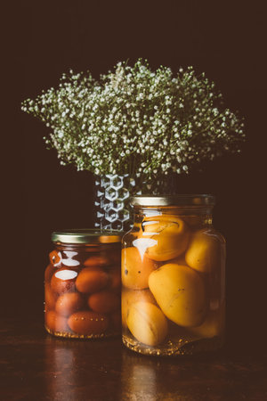glass jars preserved tomatoes flowers