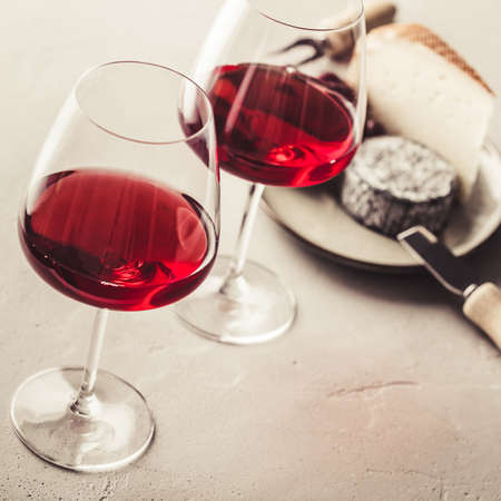 Red wine and cheese on concrete background, close upの写真素材