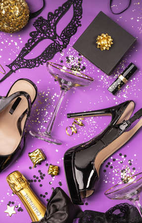 Flat lay stylish set: champagne, gifts, female sexy shoes, christmas balls and golden holiday decorationの写真素材