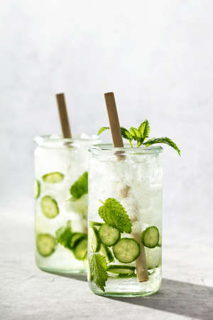 Delicious refreshing water with mint and cucumber with hard light and shadowsの写真素材