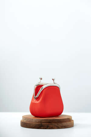 Open Red Coin Purse on wooden podium on blue backgroundの写真素材