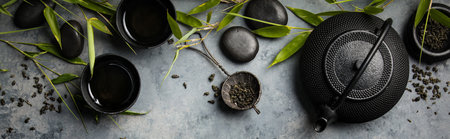 Bamboo branches and green tea on concrete background