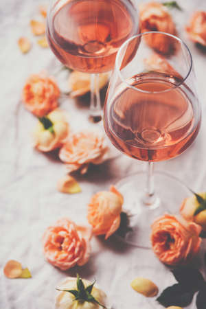 Rose wine and roses on white backgroundの写真素材