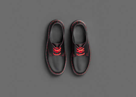 Stylish black leather shoes on black background, flat lay, top viewの写真素材