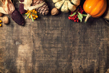 Autumn background - fallen leaves and pumpkins on old wooden table.の写真素材