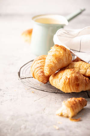 Morning coffee, croissants and spring tulips on light grey backgroundの写真素材