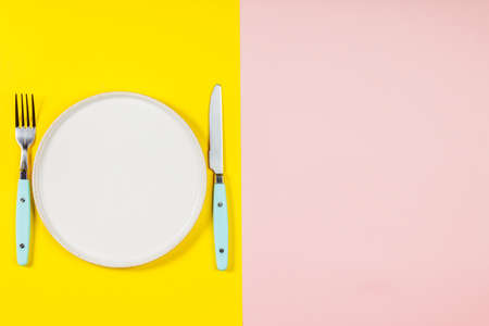 White plate on two color background, flat lay, top viewの写真素材