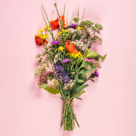 Wild flower bouquet on pastel color backgroundの写真素材