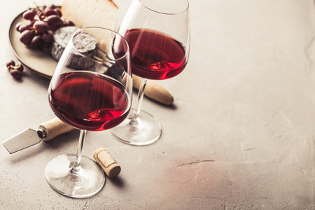 Red wine and cheese on concrete background, copyspaceの写真素材