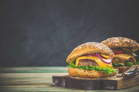 Homemade hamburgers on wooden background, space for textの写真素材