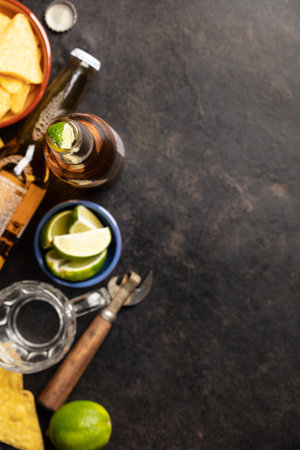 Nachos and beer on dark background, flat layの写真素材