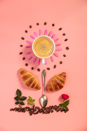 Creative layout made of alarm clock, croissants, coffee beans and flowersの写真素材
