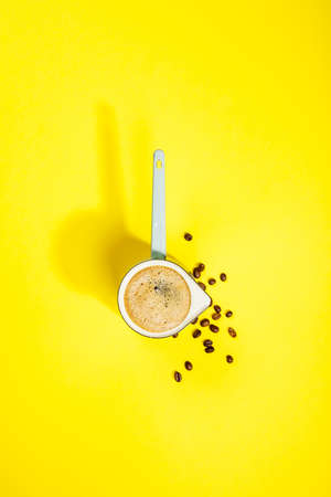 Coffee on yellow background, flat lay, top viewの写真素材