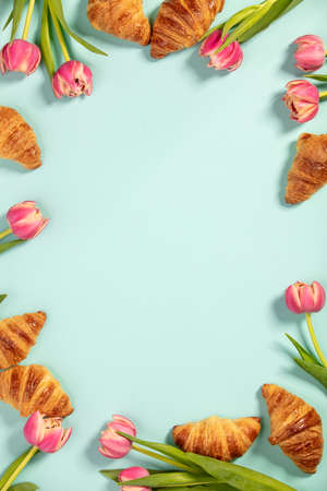 Delicious fresh mini croissants and flowers, flat layの写真素材