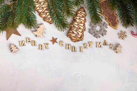 Merry Christmas written with wooden letters, cookies and Christmas decorationsの写真素材