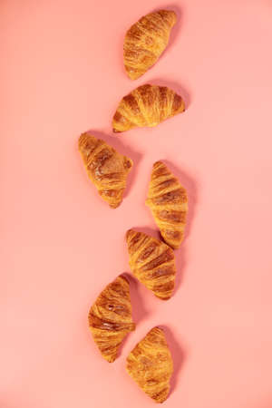 Delicious fresh mini croissants on pink backgroundの写真素材