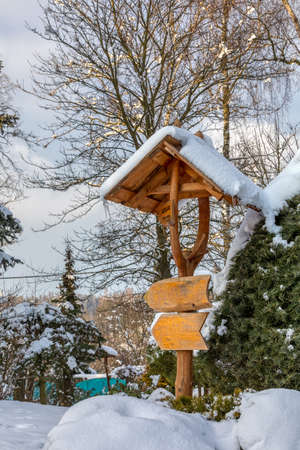 beautiful signpost in winter gardenの写真素材