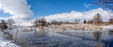 Beautiful winter rural landscape with pondの写真素材