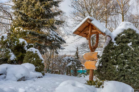 beautiful signpost in winter gardenの写真素材