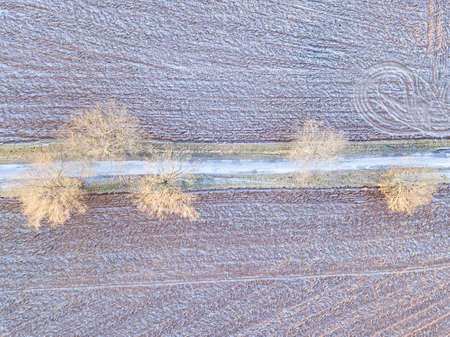 winter road with frost covered fieldsの写真素材