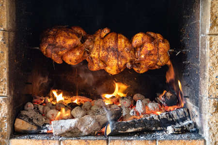 chicken roasting on a spitの写真素材