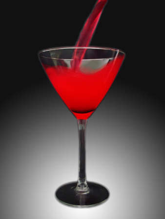 red cocktail in martini glass, black and white backgroundの写真素材