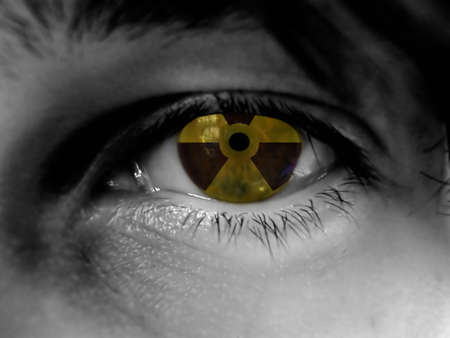 black and white part of face, radiation warning reflection in eyeの写真素材