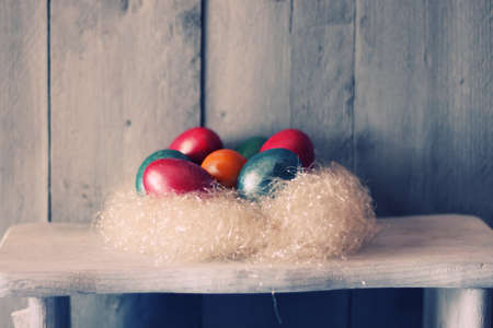 Cute photo with easter eggs in the nestの写真素材