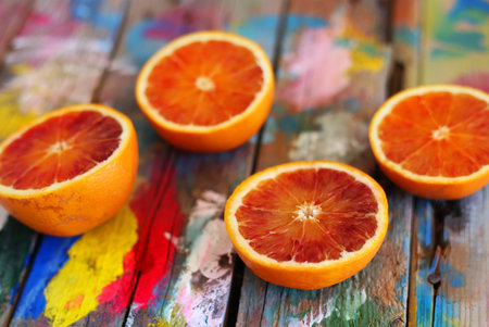 This is a photo of oranges on multi colored backgroundの写真素材
