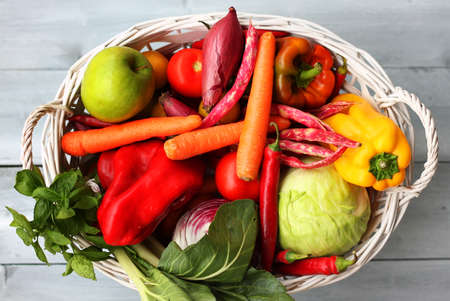 Photo of white basket with vegetablesの写真素材
