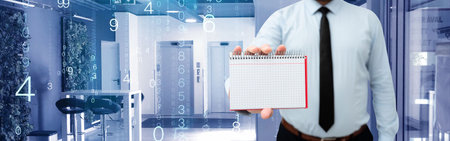 Picture Of Businessman Holding Empty Page Graphing Notebook Around Futuristic Technology. Employee Presenting Blank Workbook Surrounded By Modern Automation.の写真素材
