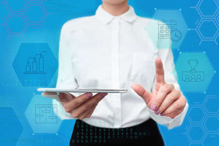Lady In Uniform Standing Holding Tablet In Hand Pressing Virtual Globe Button. Bussiness Woman Carrying Tab Poining For New Futuristic Technologies.の写真素材