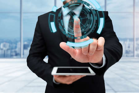 Man In Uniform Standing Holding Tablet And Virtually Typing With Pen. Business Man Carrying Pad Typing And Displaying New Futuristic Technologies.の写真素材