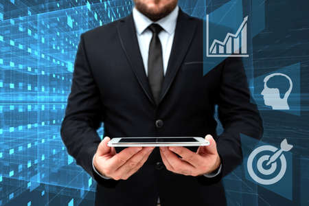 Man In Office Uniform Standing Holding Tablet Displaying New Modern Technology. Gentleman In Business Attire Carrying Tab Pointing New Futuristic Technology.の写真素材