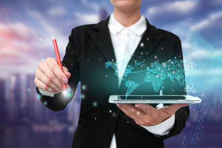 Lady In Uniform Standing Holding Tablet And Virtually Typing With Pen. Business Woman Carrying Pad Typing And Displaying New Futuristic Technologies.の写真素材