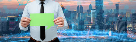 Businessman Holding Chat Box With Both Hands Around Futuristic Technology.の写真素材
