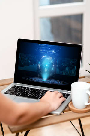 Hand Resting On Laptop Top Of Table Beside Coffee Mug Actively Accomplishing Work From Home. Arm Making New Tasks Next To Cup Finishing Remote Job Projects.の写真素材