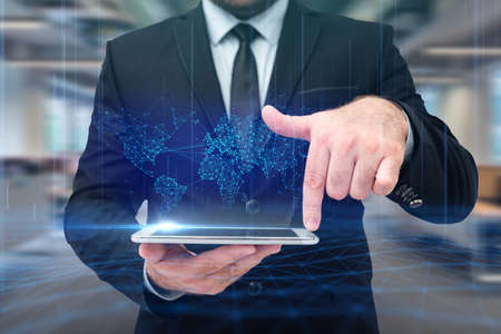 Man In Uniform Standing Holding Tablet Typing Futuristic Technologies.の写真素材