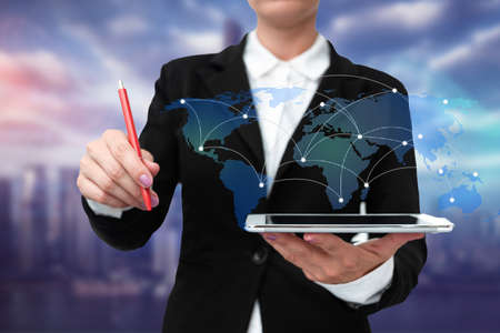 Lady In Uniform Standing Holding Tablet And Virtually Typing With Pen. Business Woman Carrying Pad Typing And Displaying New Futuristic Technologies.の写真素材