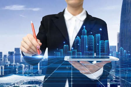 Woman In A Suit Virtually Writing On Screen Holding Tablet Showing Futuristic Technology. Businesswoman Wearing Uniform Handwriting Using Pad Presenting Modern Automation.の写真素材