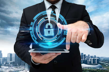 Man In Uniform Standing Holding Tablet And Virtually Tapping Screen. Business Man Carrying Pad Typing And Displaying New Futuristic Technologies.の写真素材