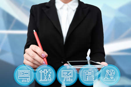 Lady In Uniform Side Standing Holding Tablet In Hand Virtually Typing On Screen. Bussiness Woman Carrying Tab Writing New Futuristic Technologies.の写真素材