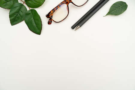 Office Supplies Over Desk With Keyboard And Glasses And Coffee Cup For Working Remotely, Assorted School Utilities For Studying With Hot Drink And Eyeglasses.の写真素材