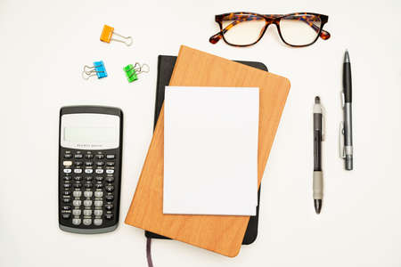Office Supplies Over Desk With Keyboard And Glasses And Coffee Cup For Working Remotely, Assorted School Utilities For Studying With Hot Drink And Eyeglasses.の写真素材